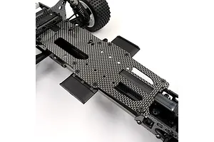 A close-up view of a carbon fiber upper deck installed on an RC car chassis, showing the weave pattern and mounting screws.