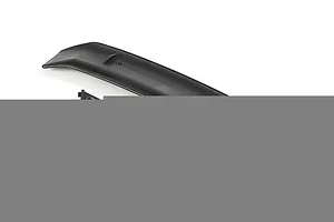 A black RC car rear wing with two mounting brackets, four small rubber grommets, and four screws on a white background.
