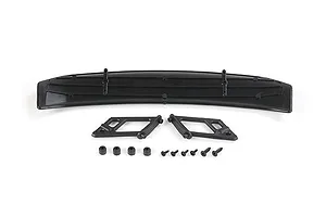 A black RC car rear wing with two mounting brackets, four small rubber grommets, and six screws arranged on a white background.