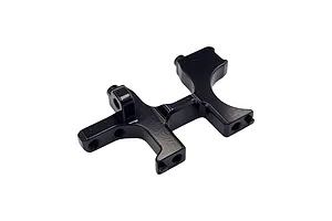 A black anodized aluminium RC car bulkhead part viewed from an elevated angle against a white background.