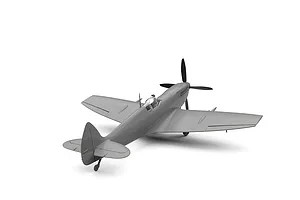 An unpainted grey plastic model of a Supermarine Spitfire Mk.IXe fighter aircraft, viewed from the rear three-quarter angle against a white background.