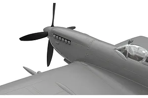 Close-up of an unpainted plastic model Spitfire aircraft showing the nose, propeller, and cockpit area against a white background.