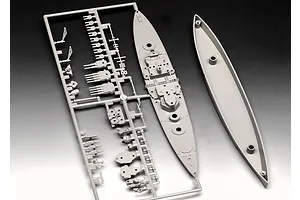 A grey plastic sprue containing parts for a 1/1200 scale battleship model kit, including the ship deck and hull pieces.
