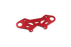A red anodized aluminium bumper plate brace for an RC car, featuring a geometric cutout design and multiple mounting holes.