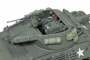 A high-angle close-up of a 1/35 scale Tamiya M36 tank destroyer model, showing the open turret interior, machine gun, and detailed stowage.