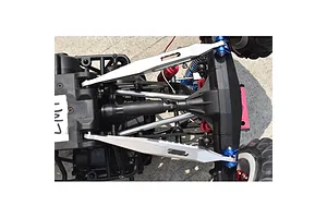 Top-down view of a silver GPM Racing lower link bar set installed on an RC vehicle chassis.