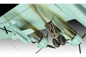 Close-up of the underside of a scale model Focke-Wulf Fw 200 aircraft showing landing gear, engine nacelles, and an external payload.