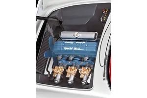 Close-up of the detailed engine bay of a 1/24 scale 1953 Chevrolet Corvette model kit, showing the Blue Flame engine with chrome and gold-painted details.