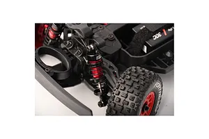 Close-up of a GPM Racing aluminium shock absorber installed on an RC car chassis with red and black components.
