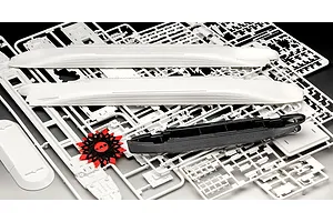 Plastic model kit parts for the RMS Titanic, including white hull sections, a black hull piece, and a red spool with black rigging thread.