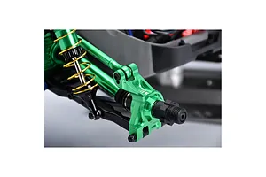 Close-up of a green anodized aluminium rear hub installed on an RC car suspension system with gold springs.