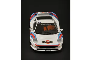 A high-angle front view of a 1/24 scale Jaguar XJ220 model car with Martini racing livery on a black background.