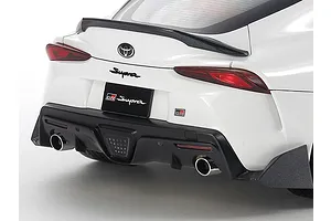 Rear view of a white Tamiya 1/24 scale Toyota GR Supra model car showing the spoiler, taillights, and dual exhaust pipes.