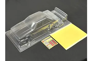 A clear, unpainted 1/10 scale RC Toyota Carina A63 body shell from Pandora RC, including a decal sheet and masking film on a black surface.