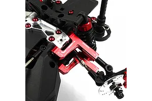 Close-up of red anodized aluminium front suspension arms installed on an RC car chassis.