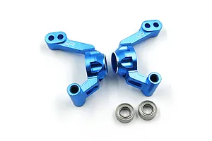 A pair of blue anodized aluminium rear hubs for RC cars by Yeah Racing, shown with two small metal ball bearings on a white background.