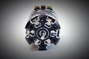 Front view of a Team Powers Actinium V5 sensored brushless motor showing the black and silver machined end bell and central output shaft.