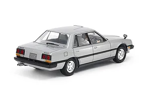 A rear three-quarter view of a silver Tamiya 1/24 scale Nissan Skyline 2000 Turbo GT-E S sedan plastic model kit, showing detailed exterior and interior.