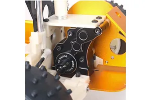 Close-up of a black Yeah Racing aluminium gearbox case installed on an RC car chassis with gold and white components.