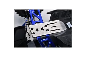A close-up view of a GPM stainless steel skid plate installed on an RC car chassis, featuring blue aluminum suspension arms and black plastic components.