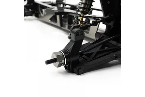 Close-up of an RC car suspension assembly featuring black aluminium parts and a metal wheel hex hub.
