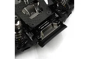 Close-up of a black aluminium Yeah Racing RC chassis component installed on a carbon fibre plate with suspension parts.