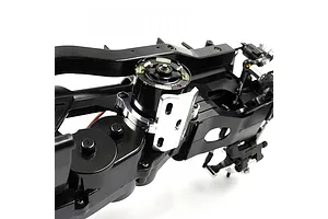 A silver aluminium motor guard installed on an RC car chassis, surrounding a black electric motor.