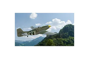 A digital rendering of a P-51 Mustang fighter plane flying over a mountainous landscape in the RealFlight simulator.