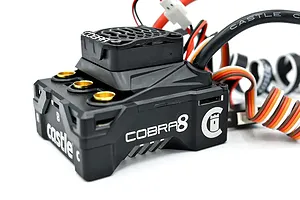 Castle Creations Cobra 8 sensored brushless ESC featuring a black cooling fan and gold-plated motor wire connectors on a white background.