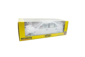 A white Mitsubishi Lancer Evolution IV RC car body shell inside a yellow Yeah Racing branded retail box.