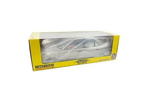 A silver Mitsubishi Lancer Evolution IV RC car body shell in its original yellow and clear window packaging.