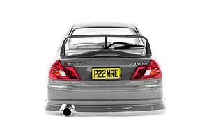 Rear view of a silver 1/10 scale Mitsubishi Lancer Evolution IV RC car body shell featuring a rear spoiler, exhaust pipe, and yellow license plate.
