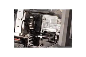 Close-up of a GPM Racing spur gear installed in an RC car drivetrain assembly.