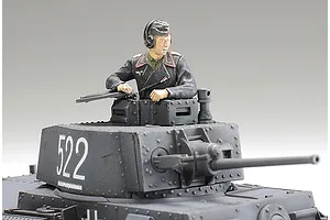 A painted 1/48 scale model tank turret with a German tank commander figure emerging from the hatch.