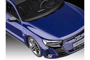 A close-up, high-angle view of a blue Revell 1/24 scale Audi E-Tron GT plastic model car showing the hood, front grille, and driver-side interior.