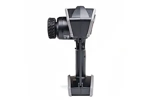 Side profile view of a black and grey Spektrum DX Rugged RC transmitter showing the steering wheel and handle.