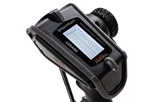 Close-up of the Spektrum DX Rugged radio transmitter showing the LCD screen displaying monitor settings and the rubberized protective casing.