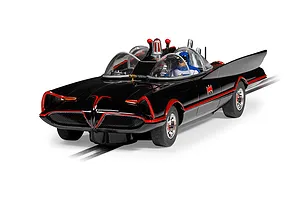 A 1/32 scale Scalextric Batmobile slot car in black with red trim, featuring a Batman figure in the cockpit, positioned on a slot car track.