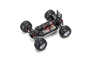 High-angle studio shot of a Kyosho Mad Van RC monster truck chassis showing the motor, battery, and suspension components.