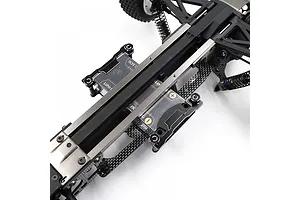 A close-up view of a Yeah Racing aluminium and carbon fibre short battery holder installed on an RC car chassis.