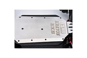 GPM Racing stainless steel chassis skid plate installed on an RC vehicle, featuring engraved GPM, Kraton, and EXB branding.