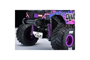 A close-up view of the rear of an RC monster truck, showing a silver GPM branded metal skid plate installed on the chassis.