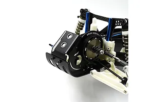 A close-up view of a black aluminium motor mount plate installed on an RC car chassis, featuring the Yeah Racing logo and gear assembly.