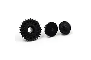 Three black nylon RC gears of varying sizes arranged in a row on a white background.