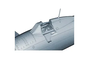 Close-up of the cockpit area of an unpainted grey plastic model aircraft kit, showing detailed panel lines and rivets.