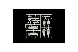 A white plastic model kit sprue containing car parts including seats and bumper sections for a 1/24 scale model car.
