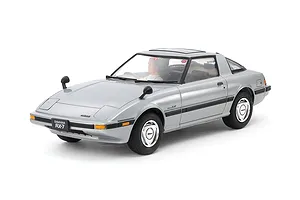 A fully assembled and painted 1/24 scale Tamiya Mazda Savanna RX-7 model car in silver, shown from a front three-quarter angle on a white background.