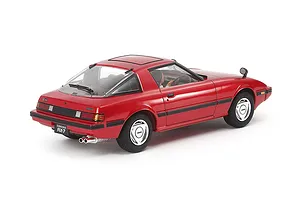 A 1/24 scale Tamiya model of a red Mazda Savanna RX-7, viewed from the rear three-quarter angle on a white background.