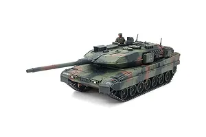 A fully assembled and painted 1/48 scale Tamiya Leopard 2 A7V model tank with a camouflage pattern and a crew figure in the hatch.