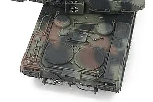 Top-down view of the rear engine deck of a Tamiya 1/48 scale Leopard 2 A7V tank model, showing detailed camouflage paint and molded tools.